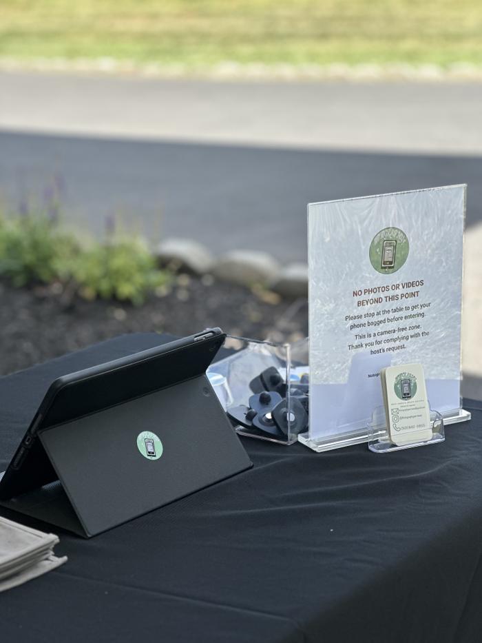 Notography guest check-in station with signage and equipment